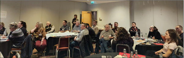 A group of farmers and crofters face the front of a room at the first Pan-Island Network meeting.
